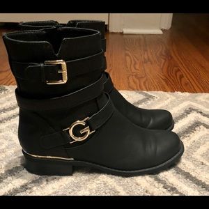G by Guess brand black booties with gold detail.